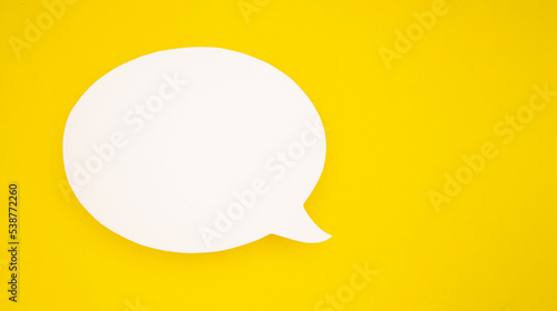 A blank white speech bubble over a yellow background