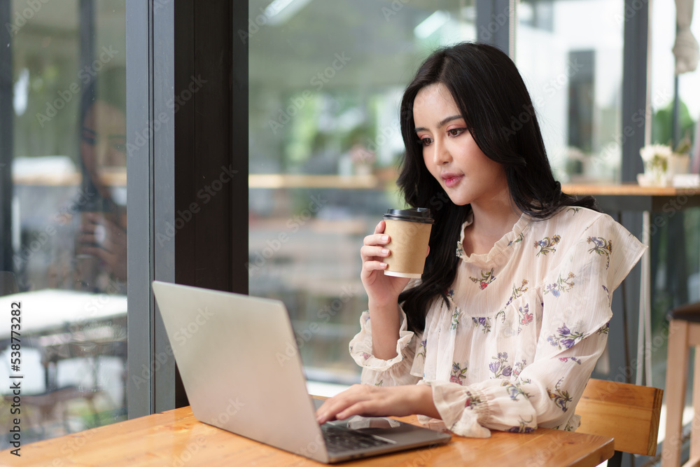Fototapeta premium Businesswoman Working Alone On Laptop In Office Boardroom