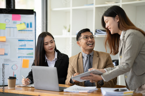 Group of young Asian business people or creative team in brainstorm discussion meeting in office. © PaeGAG