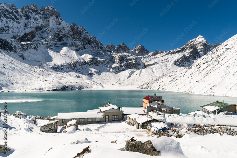 Gokyo, Nepal; Stunning view of the famous Gokyo lake and village facing the Renjo La pass after a fresh snowfall in the Everest area of the Himalaya in Nepal in winter