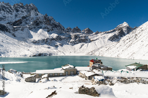 Gokyo, Nepal; Stunning view of the famous Gokyo lake and village facing the Renjo La pass after a fresh snowfall in the Everest area of the Himalaya in Nepal in winter photo