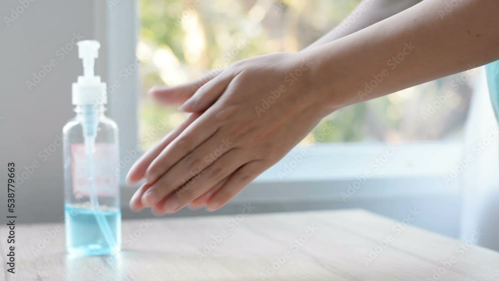 woman cleaning her hands gel placed on the table for washing hands To