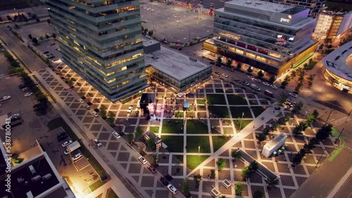 4k Aerial drone view of contemporary urban plaza at night, Vaughan Metropolitan Centre in Ontario, Canada. photo