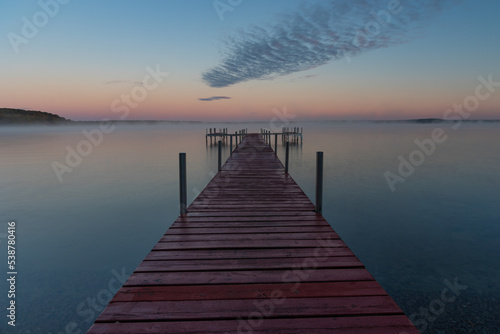 Fototapeta Naklejka Na Ścianę i Meble -  Dock on Mullett Lake in Indian River Michigan with pastel skies overhead