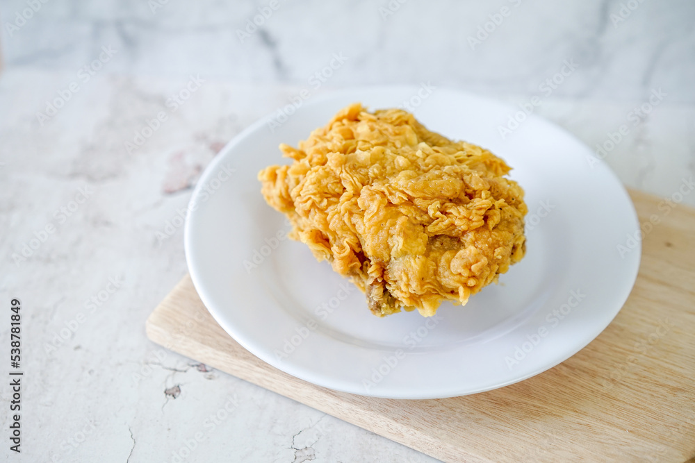 Fried chicken crisp, fast food meal on a white plate Fried chicken crisp, fast food meal on a white plate