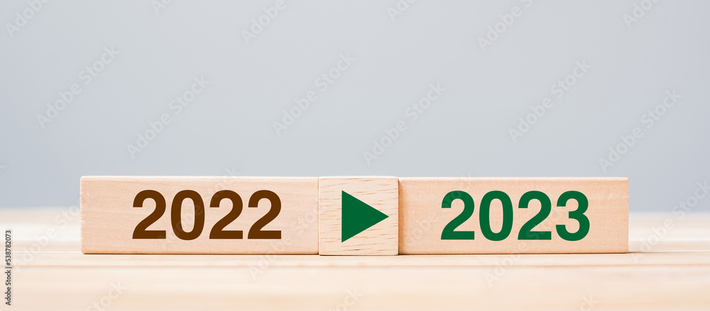 2023 and 2022 wooden block on table background. Resolution, strategy, countdown, goal, change and New Year holiday concepts 2023 and 2022 wooden block on table background. Resolution, strategy, countdown, goal, change and New Year holiday concepts