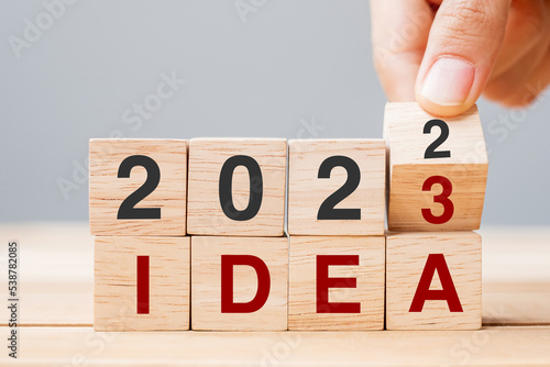 hand flipping block 2022 to 2023 IDEA text on table. goal, Resolution, strategy, plan, motivation, reboot, business and New Year holiday concepts