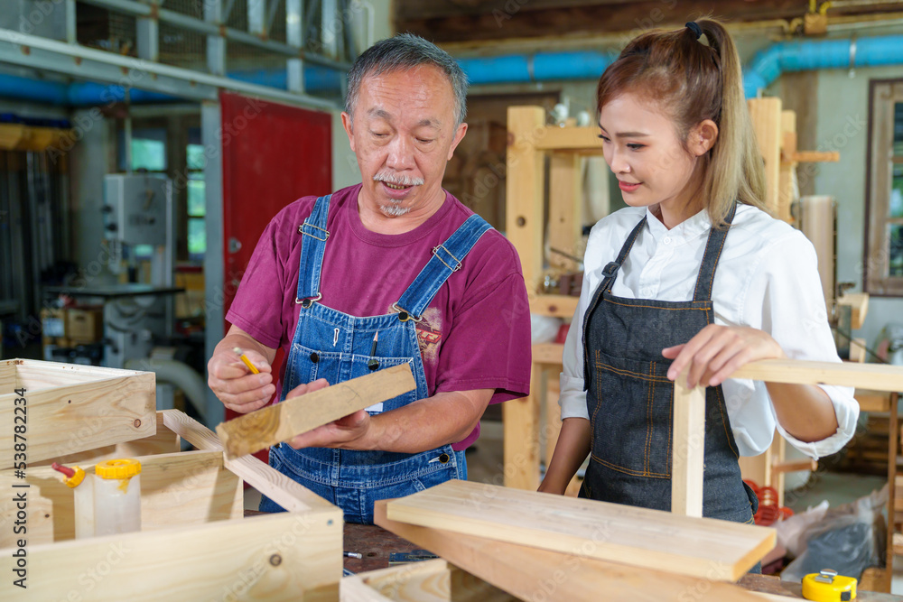 Teacher explaining a structure students while standing in a woodwork class Teacher explaining a structure students while standing in a woodwork class