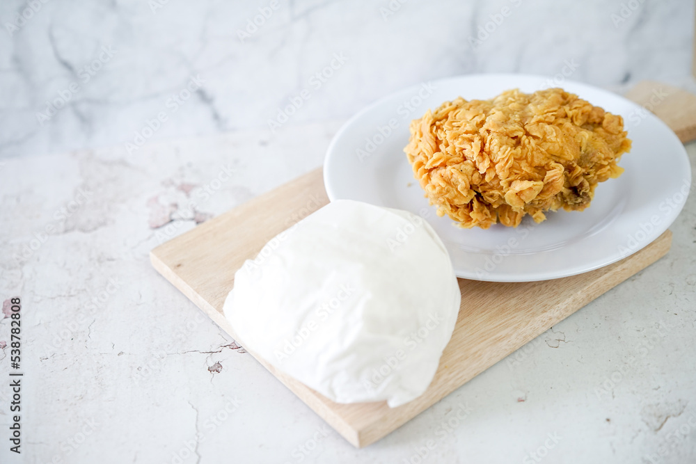 Fried chicken crisp with rice, fast food meal on a white plate Fried chicken crisp with rice, fast food meal on a white plate