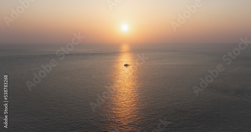 Speedboats sail along the sea in the middle of the light of the sunset. Shot at Promthep Cape, Phuket, Thailand