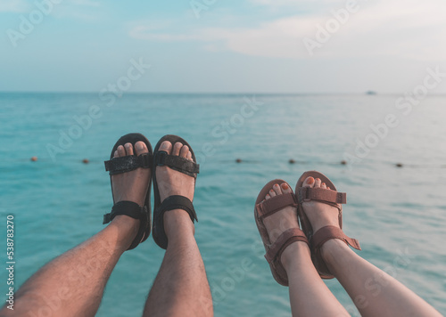 Both men and women stand forward with both legs. And the background is sea.
