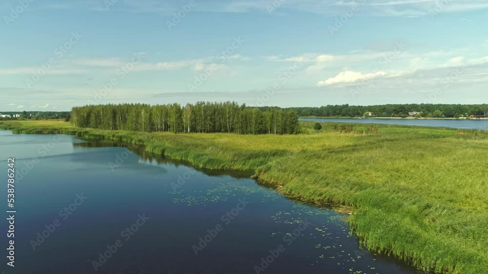 Beautiful drone shot summer sun green fields and blue river with boat Beautiful drone shot summer sun green fields and blue river with boat