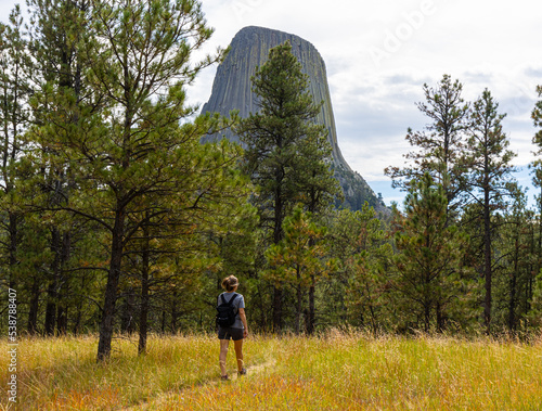 Female Hiker With View of Devils Tower From The Joyner Ridge Trail, Devils Tower National Monument, Wyoming, USA photo