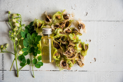 Moringa Oil and seeds, The seeds of the Moringa tree are pressed oil known as Ben Oil yellow photo