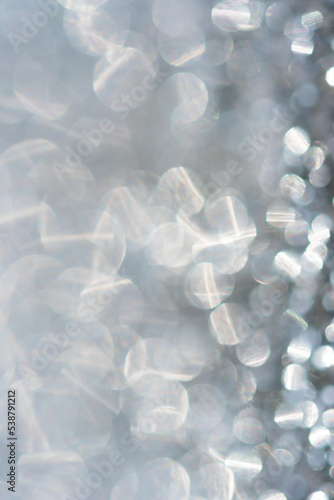 silver and white bokeh lights abstract background
