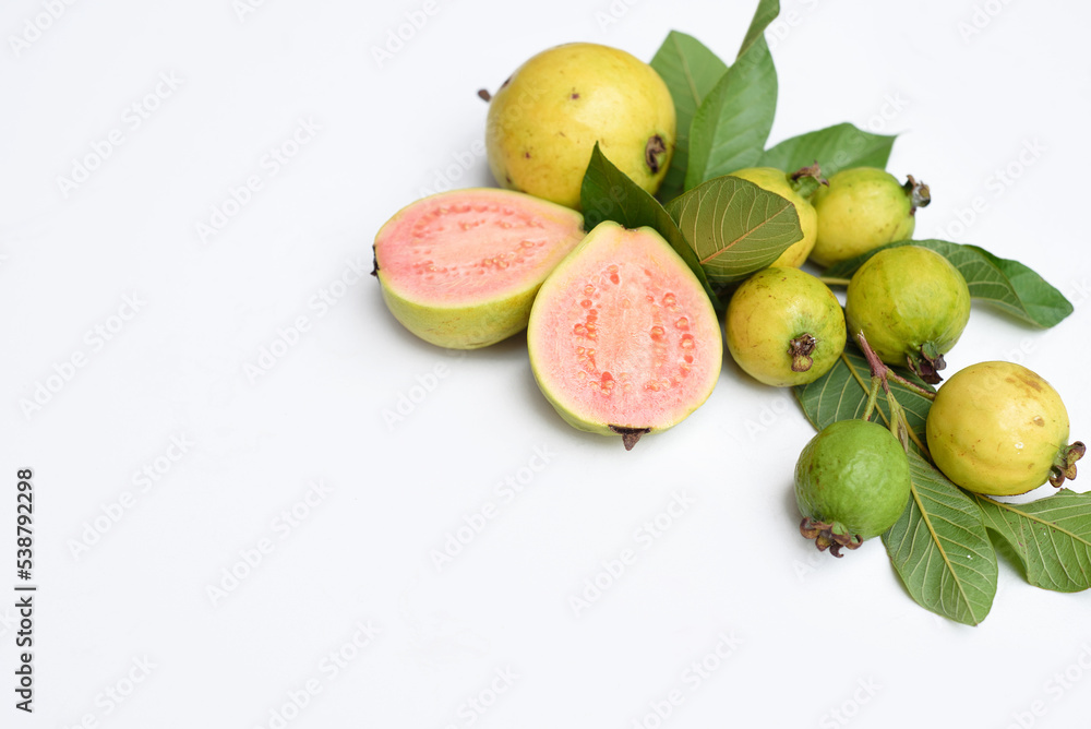 Ripe guava fruit with leaves on white background with copy space Ripe guava fruit with leaves on white background with copy space