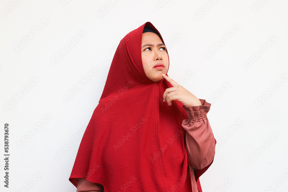 Portrait of attractive muslimah wearing hijab thinking and contemplate looking at copy space isolated on white color background Portrait of attractive muslimah wearing hijab thinking and contemplate looking at copy space isolated on white color background