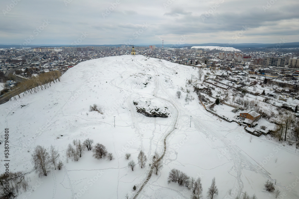 Fototapeta premium Flight over Lisya mountain or Fox mountain in the city of Nizhny Tagil, Russia. Aerial view