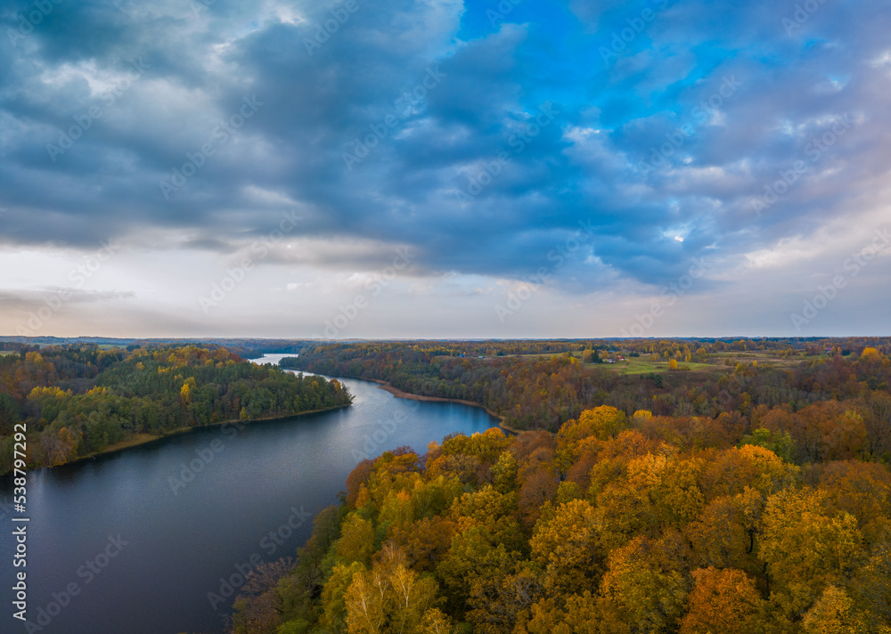 Autumn view with Asveja lake and colorful mapple trees