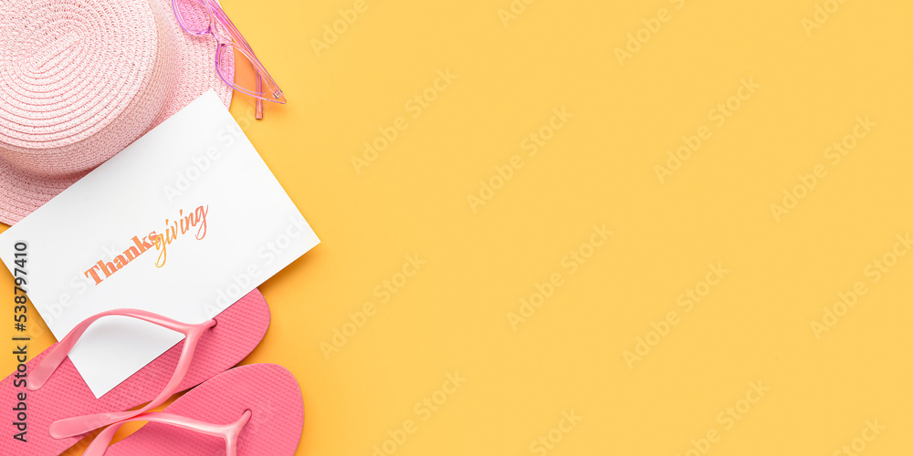 Greeting card with text HAPPY THANKSGIVING and beach accessories on yellow background with space for text Greeting card with text HAPPY THANKSGIVING and beach accessories on yellow background with space for text