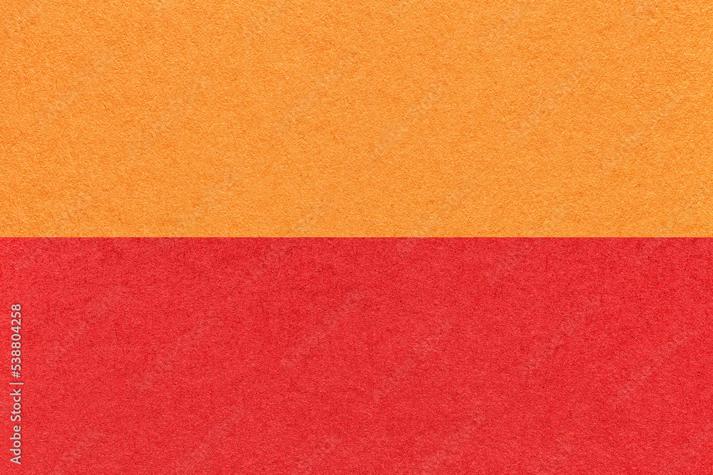 Texture of craft bright orange and red paper background, half two colors, macro. Vintage dense ruby cardboard. Texture of craft bright orange and red paper background, half two colors, macro. Vintage dense ruby cardboard.