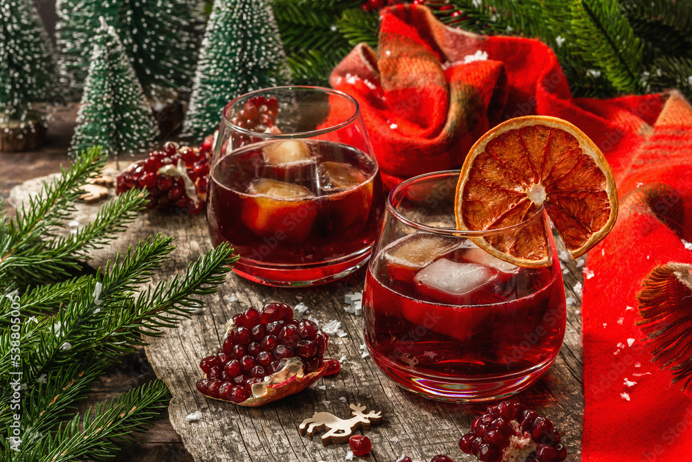 Non-alcoholic cocktail with fruits syrup and ice. Christmas traditional decor, New Year arrangement Non-alcoholic cocktail with fruits syrup and ice. Christmas traditional decor, New Year arrangement