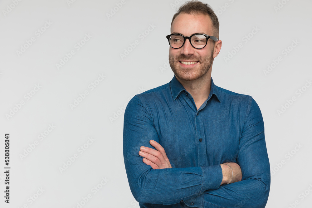 casual man is smiling wide, crossing his arms casual man is smiling wide, crossing his arms