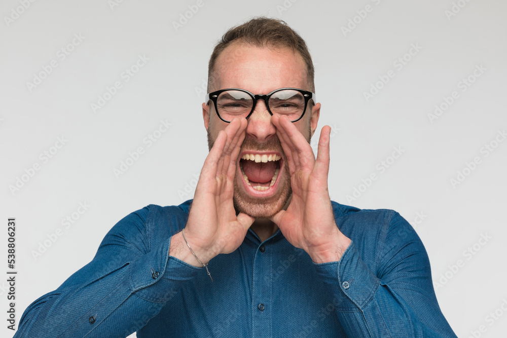 young casual man is screaming out loud young casual man is screaming out loud