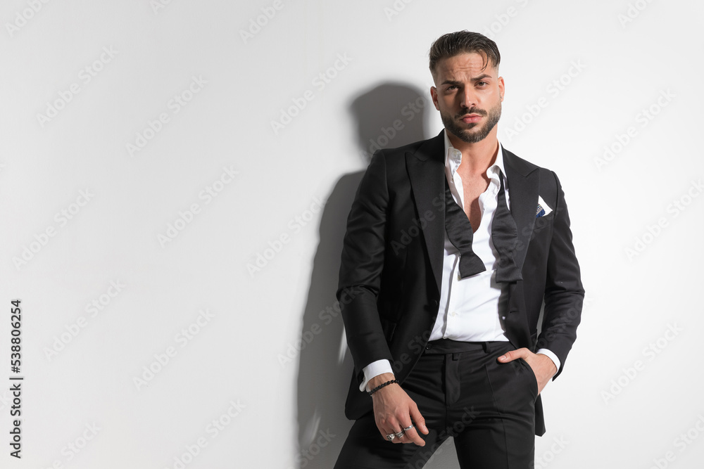 businessman with tough attitude is holding one hand in pocket businessman with tough attitude is holding one hand in pocket