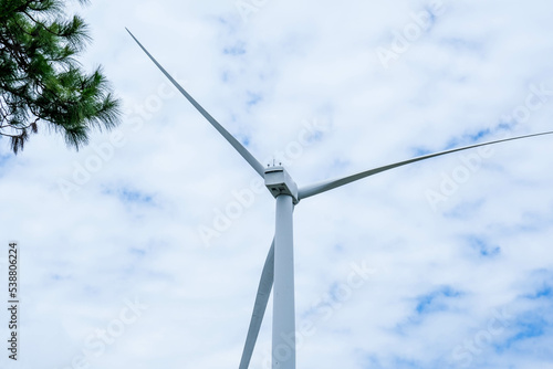 Windmill for electric power production with beautiful landscapes and blue skies to generate clean renewable green energy for sustainable development.