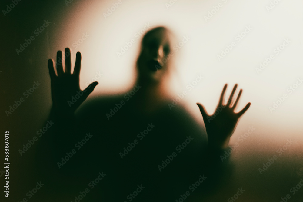 Shadowy figure behind glass - horror background