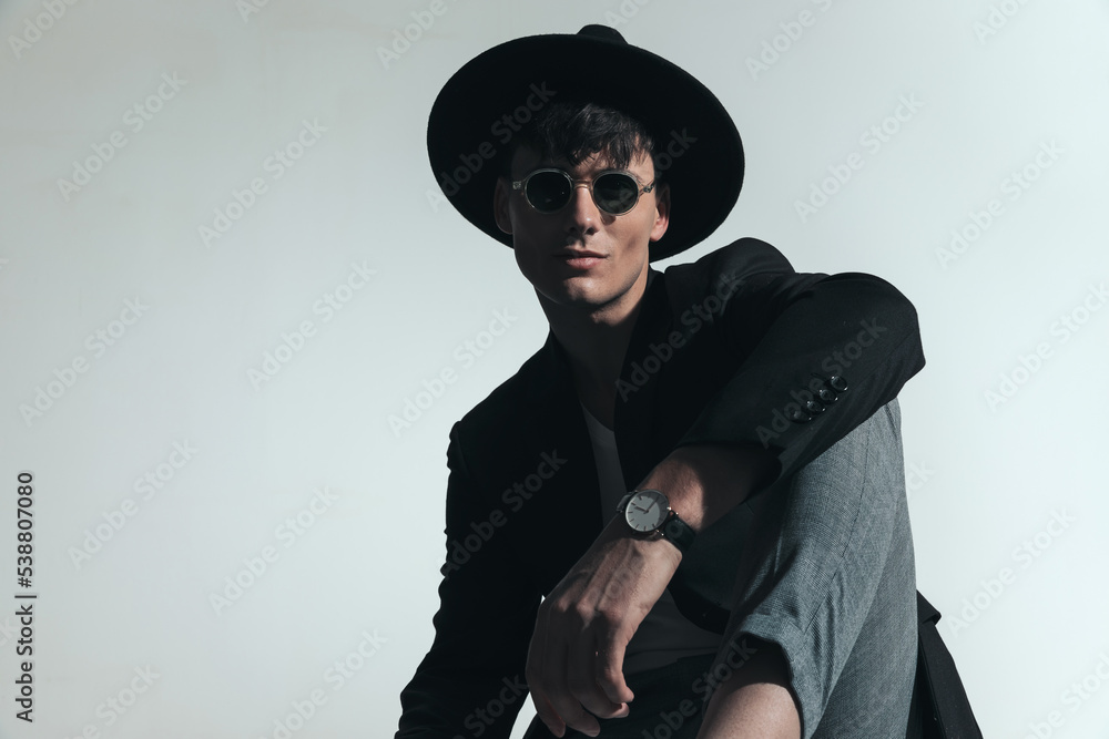 handsome stylish man with hat and sunglasses posing in a cool way handsome stylish man with hat and sunglasses posing in a cool way
