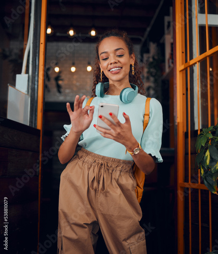 Happy gen z young woman with smartphone, social media fashion influencer in trendy cafe and youth culture in Miami. .Trendy student communication, reading text on cell and 5g technology connection photo