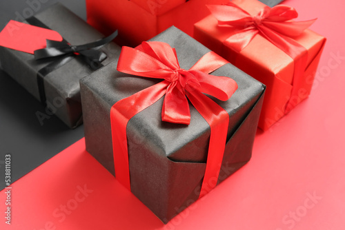 Gift boxes on color background, closeup. Black Friday sale