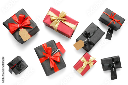 Gift boxes with price tags on white background. Black Friday sale