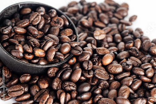 Coffee Beans on white background. close up. Coffee grounds. Freshly roasted coffee beans. Image of a drink made from granules, derived from coffee plant. Copy space for text.