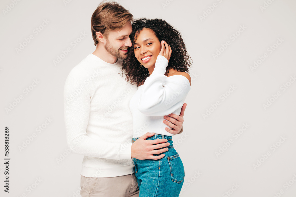 Smiling beautiful woman and her handsome boyfriend. Happy cheerful multiracial family having tender moments on grey background in studio. Multiethnic models hugging. Embracing each other.Love concept Smiling beautiful woman and her handsome boyfriend. Happy cheerful multiracial family having tender moments on grey background in studio. Multiethnic models hugging. Embracing each other.Love concept