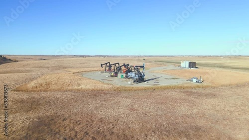 Oil rigs extract crude oil from the earth near Calgary Alberta Canada as seen from a drone photo