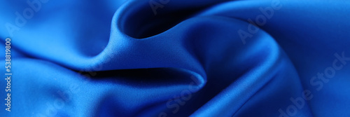 Blue satin fabric closeup. Natural fabric or polyester satin concept