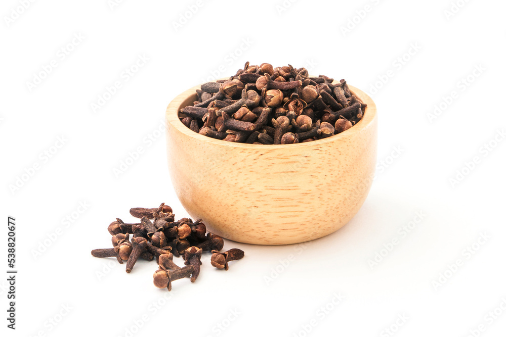 cloves or spice in wooden bowl isolated on white background. cloves or spice in wooden bowl isolated on white background.