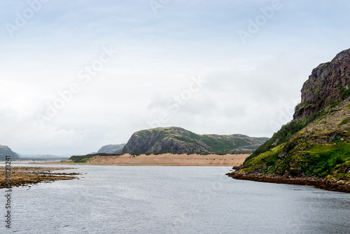 Summer tundra. Rocky coastline of Barents Sea near Teriberka. Scenery of Russian North. Kola Peninsula, Murmansk Oblast, Russia