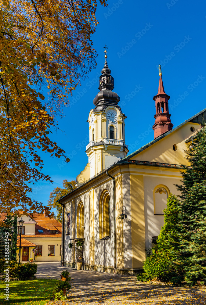 St. Matthias church, kosciol sw. Macieja, under autumn colors in historic old town quarter of Andrychow in Poland St. Matthias church, kosciol sw. Macieja, under autumn colors in historic old town quarter of Andrychow in Poland