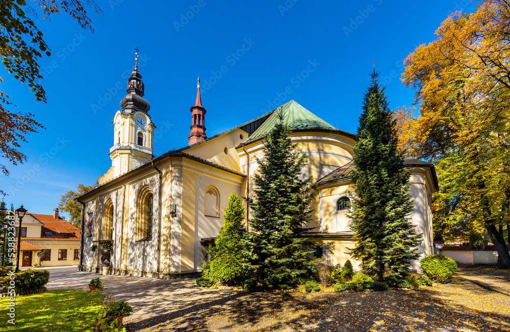St. Matthias church, kosciol sw. Macieja, under autumn colors in historic old town quarter of Andrychow in Poland