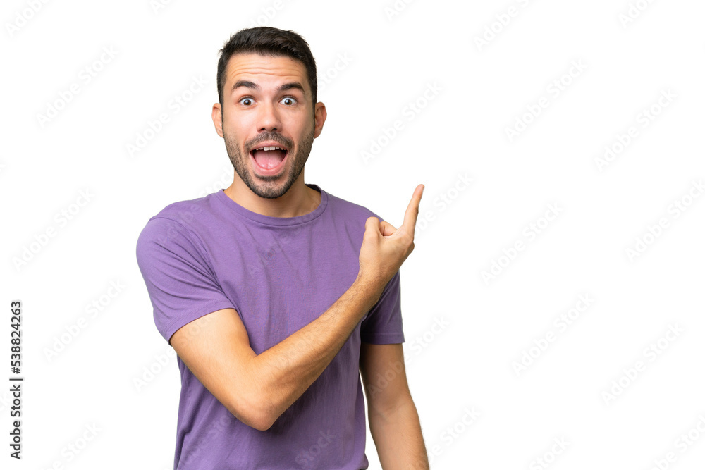 Young handsome caucasian man over isolated background surprised and pointing side Young handsome caucasian man over isolated background surprised and pointing side