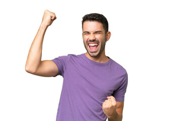 Young handsome caucasian man over isolated background celebrating a victory