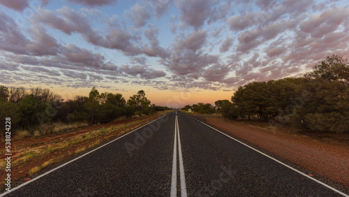 Straight line on an Australian highway through the outback at dusk 