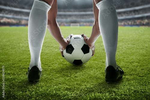 Fototapeta Naklejka Na Ścianę i Meble -  Soccer player holding ball in the stadium