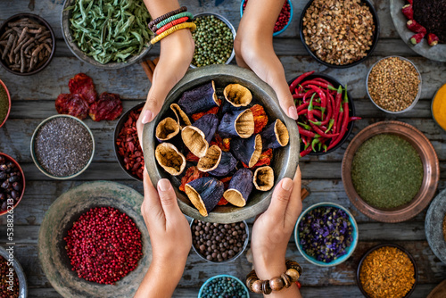 Dried vegetables at the hands of two women photo