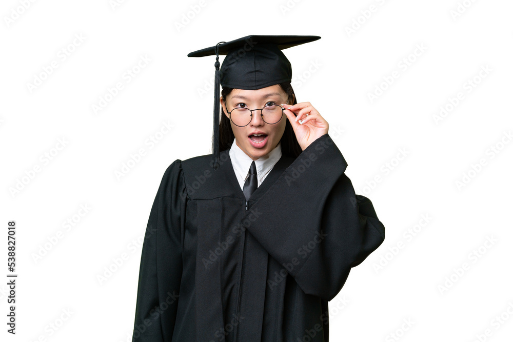 Young university graduate Asian woman over isolated background with glasses and surprised Young university graduate Asian woman over isolated background with glasses and surprised