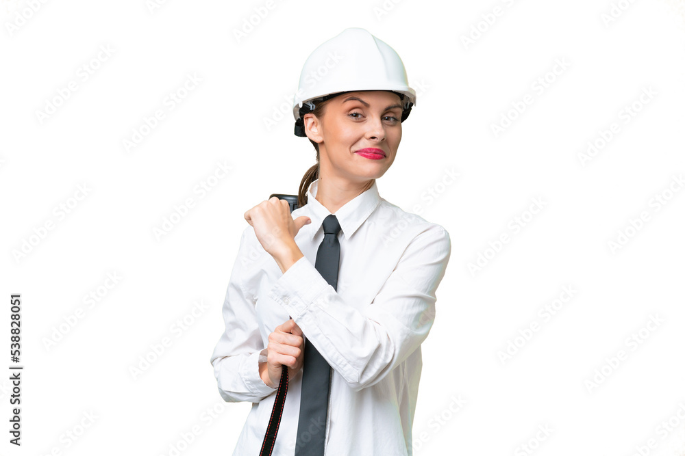 Young architect woman with helmet and holding blueprints over isolated background proud and self-satisfied Young architect woman with helmet and holding blueprints over isolated background proud and self-satisfied